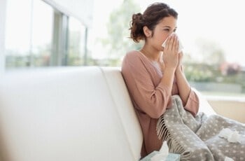 a woman blowing her nose